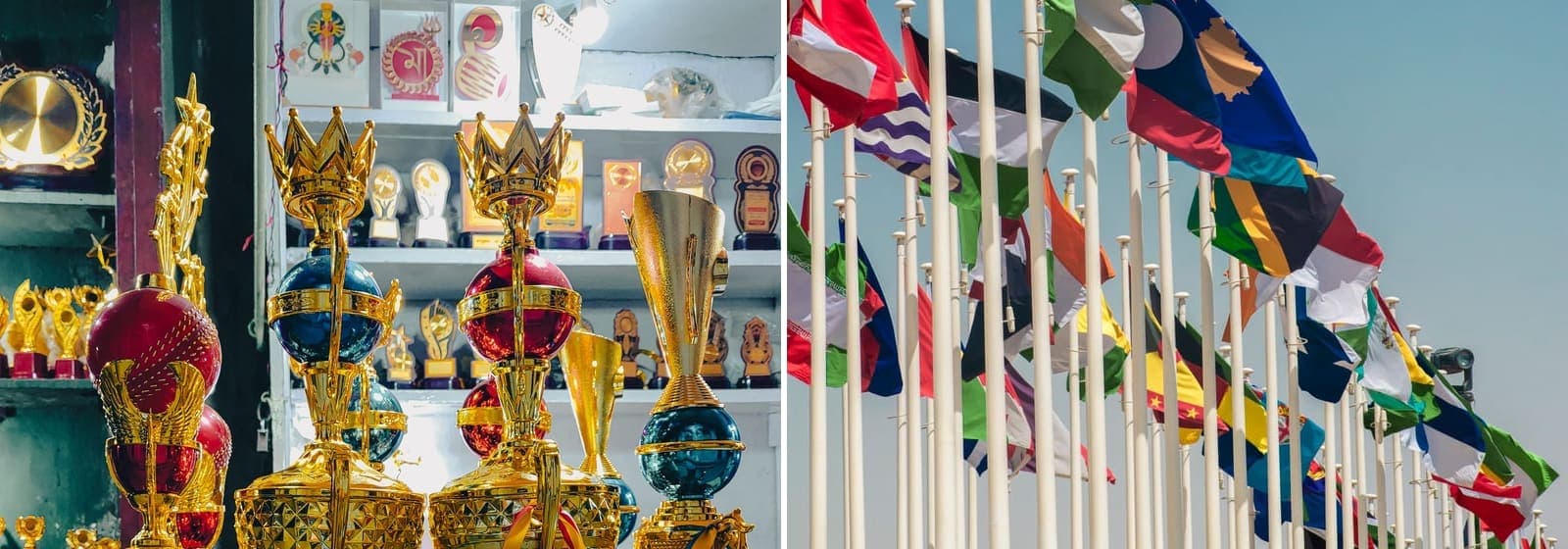 Golden trophies on display on the left and national flags on tall poles on the right